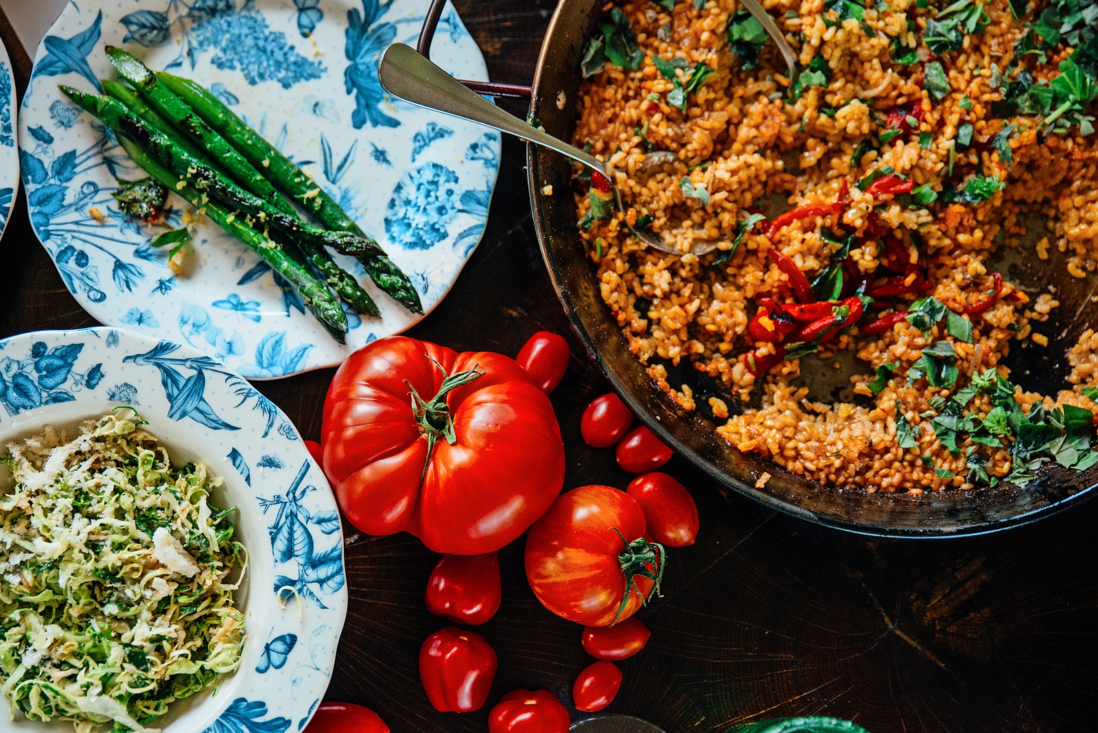 Forest kitchen at Limewood with paella, grilled asparagus, and salad.