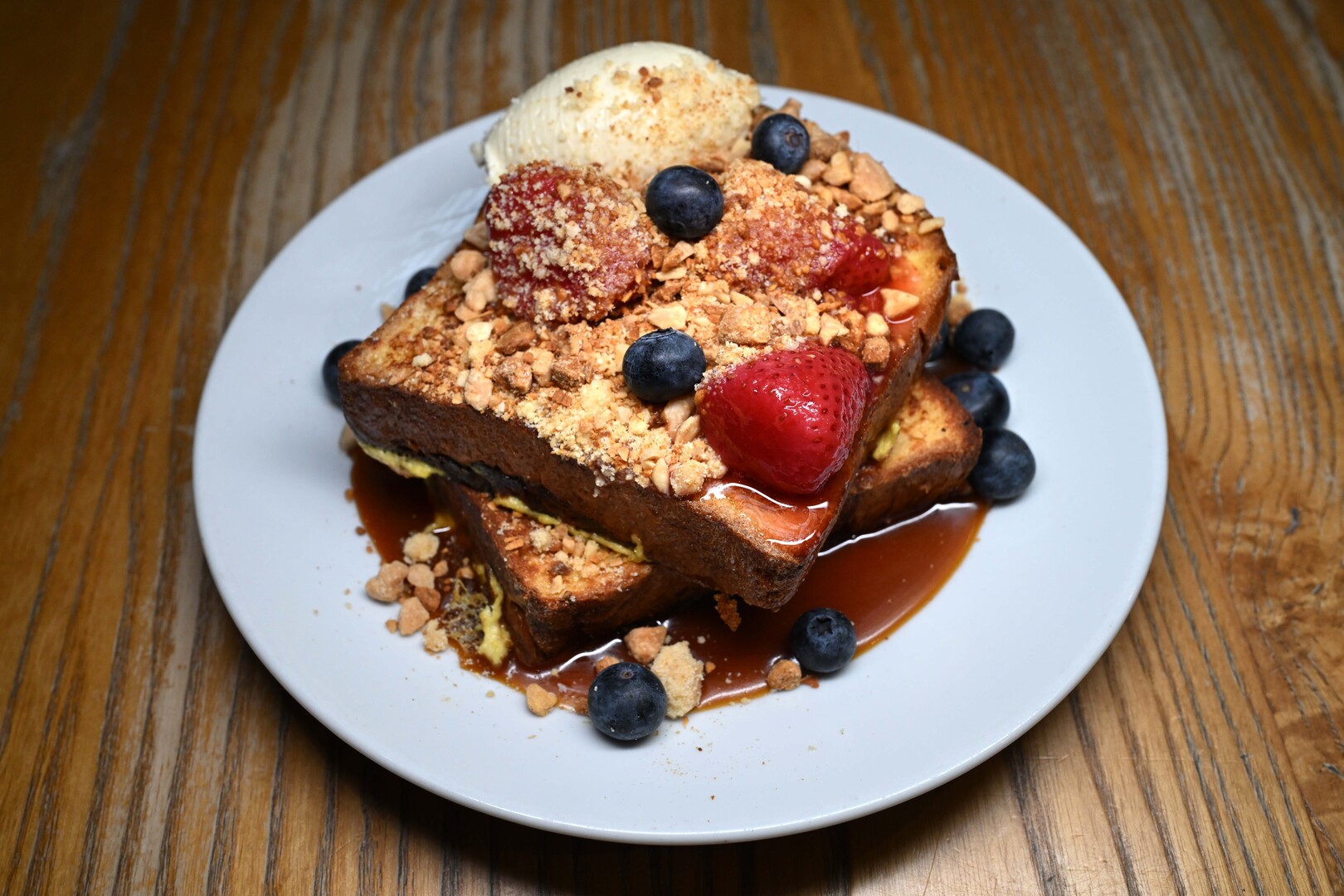 French toast with strawberries, blueberries, and ice cream.